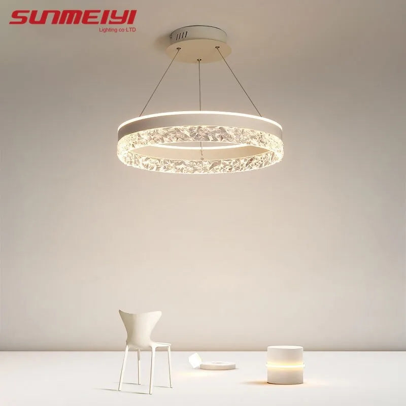 Modern luxe LED ring chandelier suspended in a contemporary living room with elegant minimalist décor.