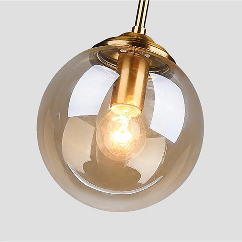 Luxury Nordic glass LED pendant light hanging above a modern dining table in a contemporary home.