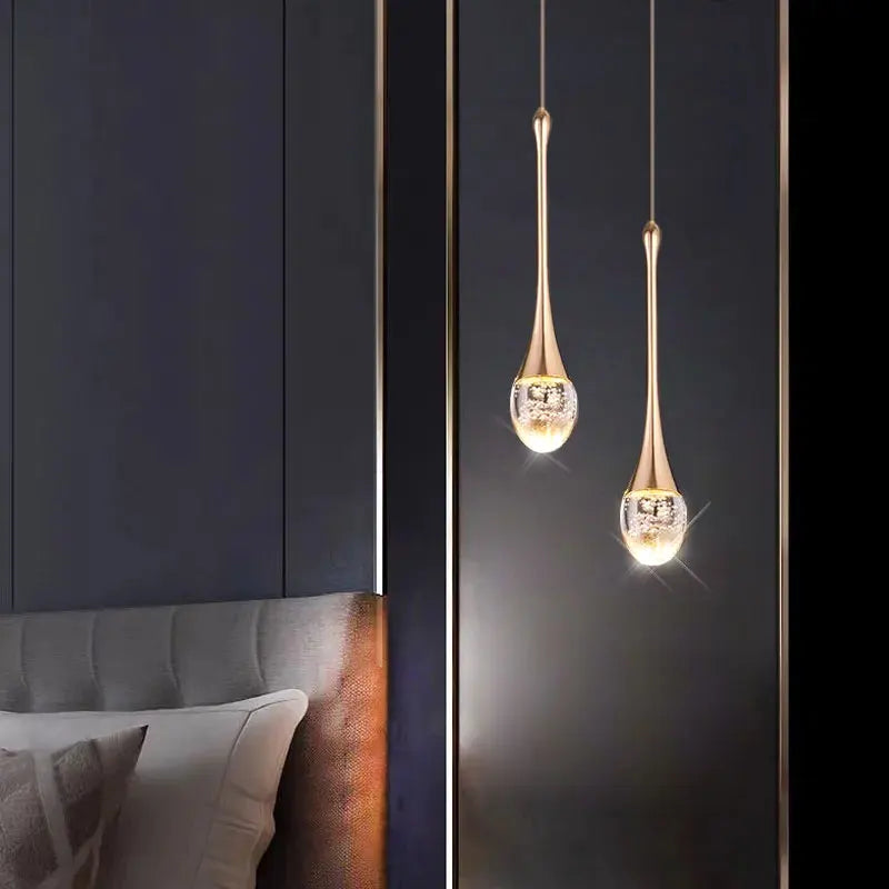Modern bubble crystal pendant light hanging above a kitchen island in a luxury contemporary home.
