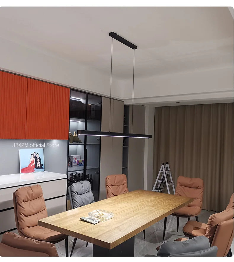 Modern linear LED pendant light suspended above a dining table in a contemporary dining room.