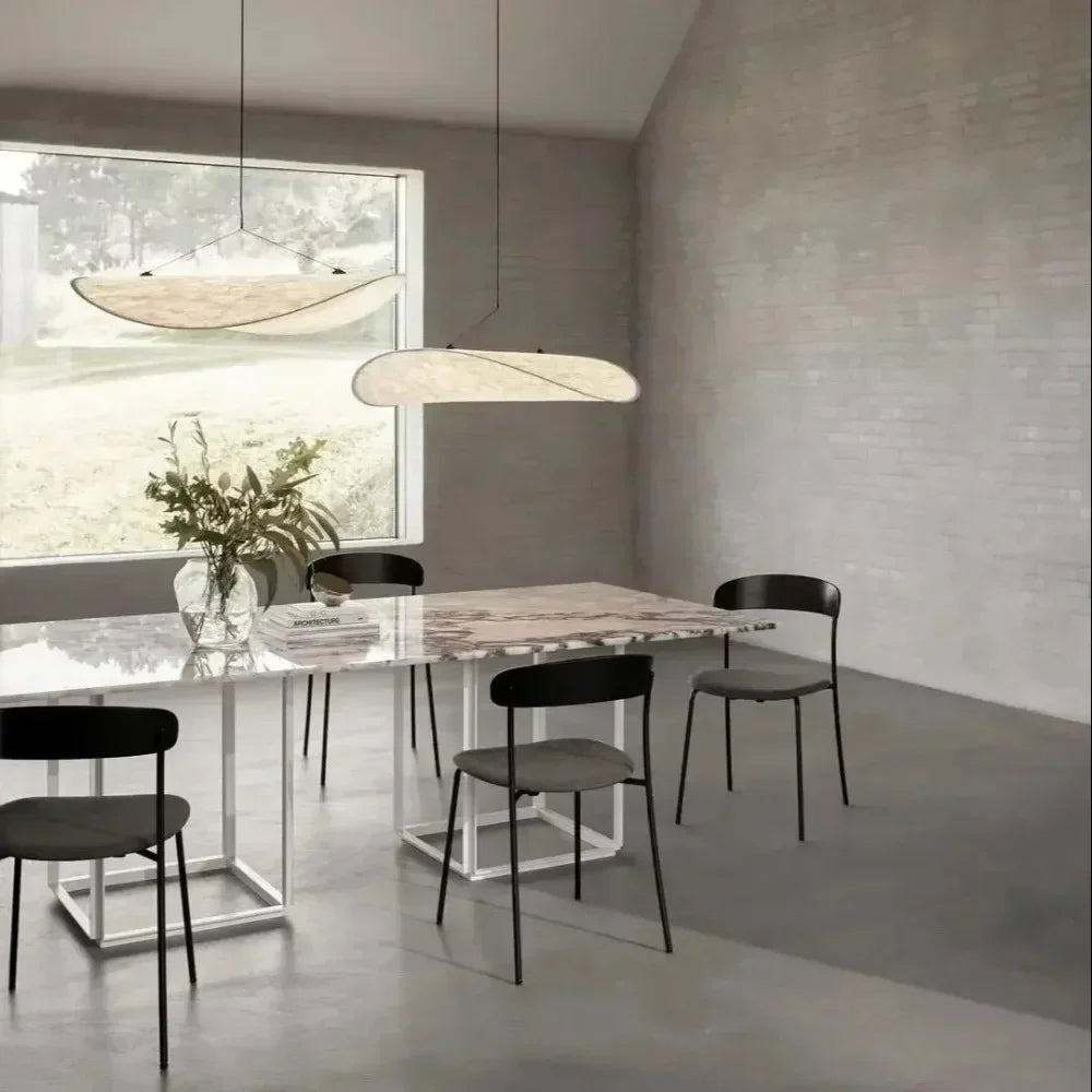 Nordic modern LED pendant light hanging above a dining table in a contemporary living room.