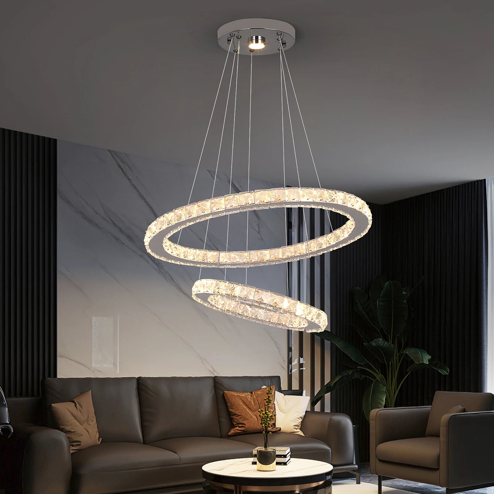 Luxury crystal ring LED chandelier suspended above a modern dining table in an elegant contemporary home.