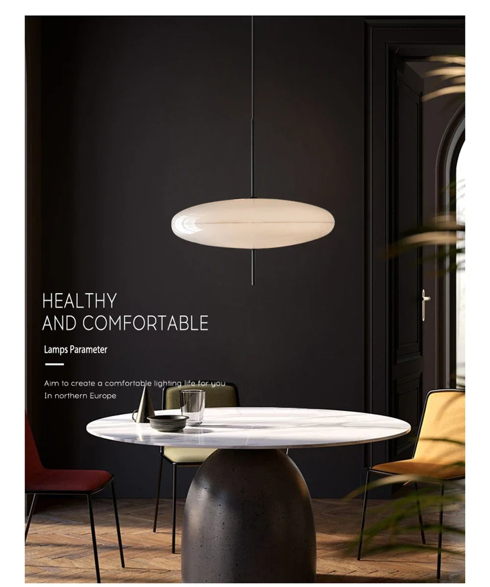 Nordic flying saucer LED pendant light hanging in a modern living room with minimalist décor.