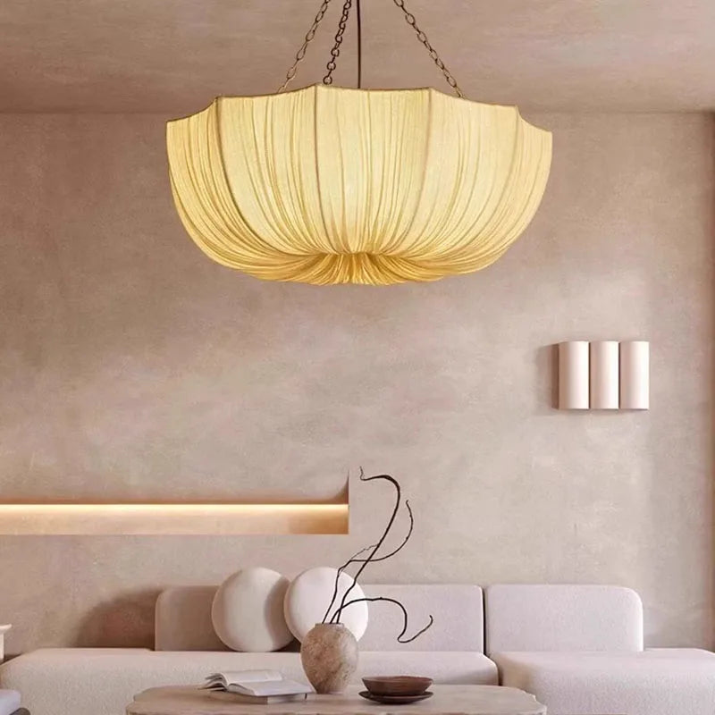 Japanese fabric pendant light with iron chain hanging above a modern dining table in a Japandi-style home.