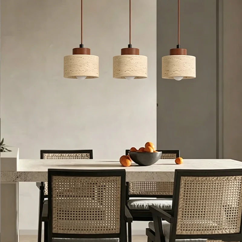 Wabi-Sabi Japanese pendant light with a natural stone-inspired shade hanging beside a modern bed.