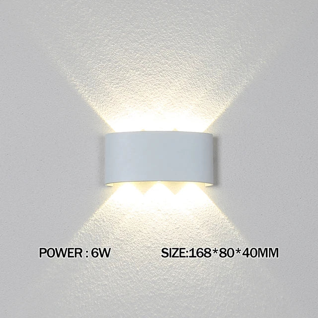 Modern waterproof LED wall light installed on an exterior house wall illuminating a porch and garden.