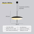 Nordic flying saucer LED pendant light hanging in a modern living room with minimalist décor.