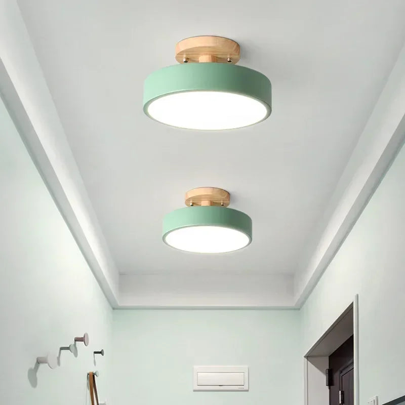 Nordic wood round LED ceiling light installed in a modern hallway with Scandinavian-inspired interior décor.