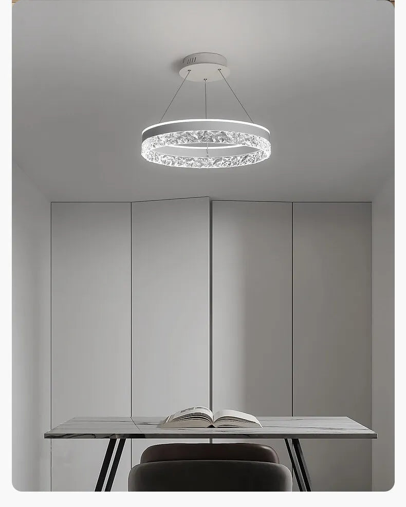 Modern luxe LED ring chandelier suspended in a contemporary living room with elegant minimalist décor.