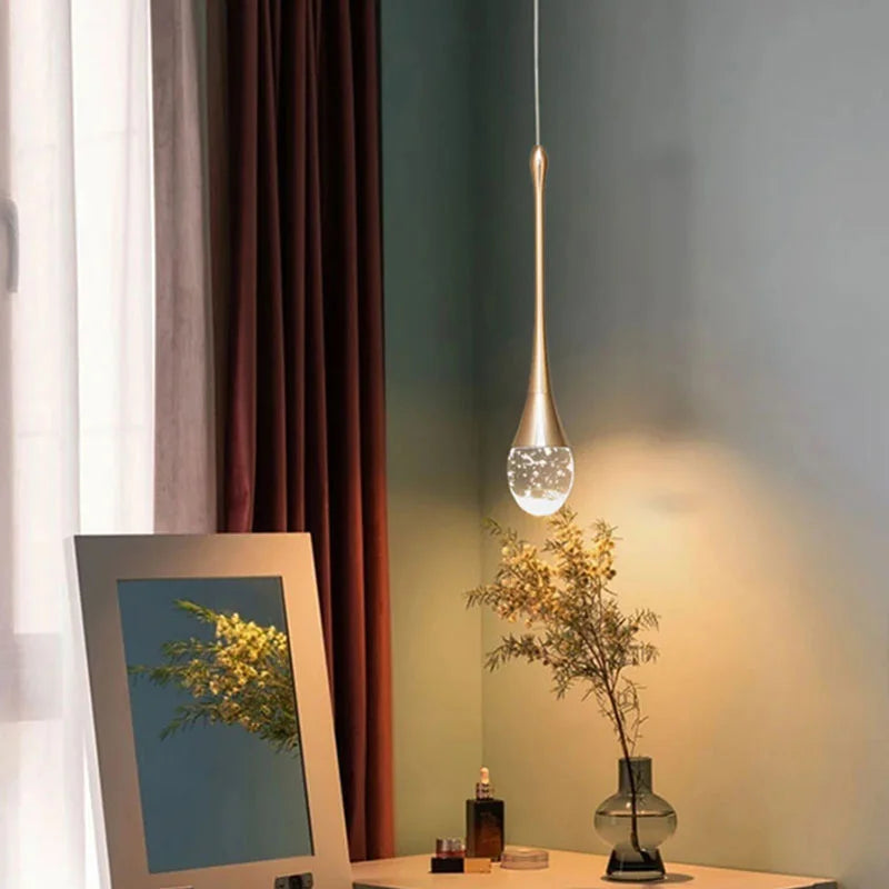 Modern bubble crystal pendant light hanging above a kitchen island in a luxury contemporary home.