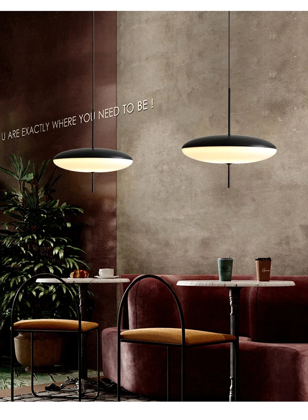 Nordic flying saucer LED pendant light hanging in a modern living room with minimalist décor.