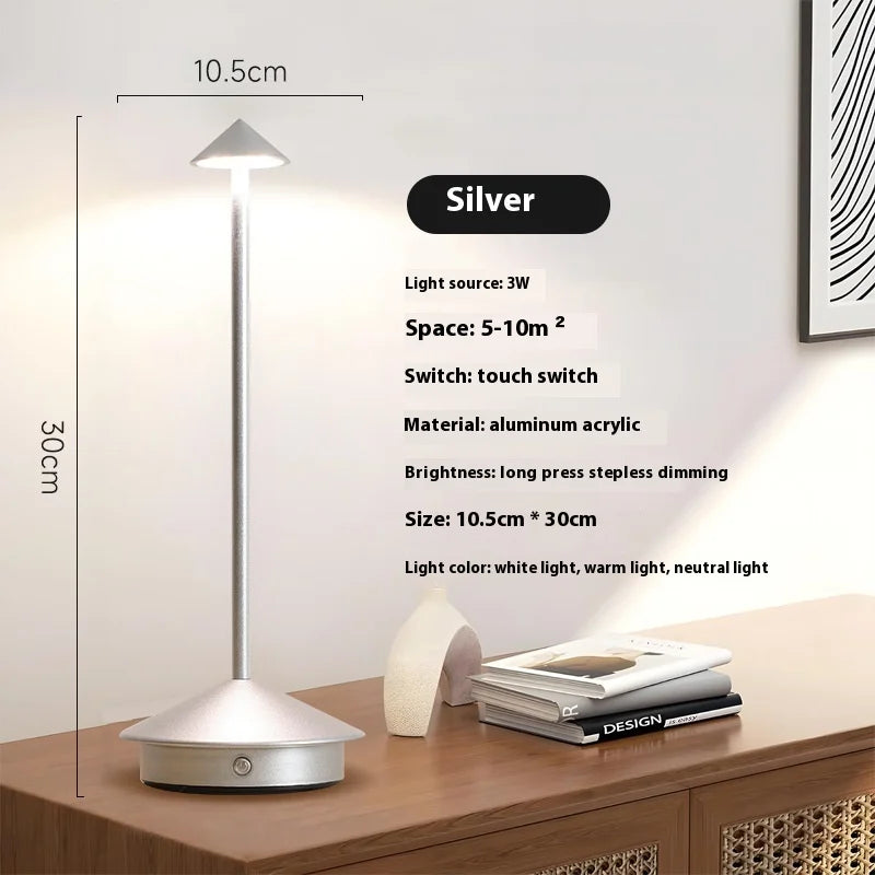 Rechargeable touch LED table lamp placed on a modern dining table in a stylish café-inspired interior.