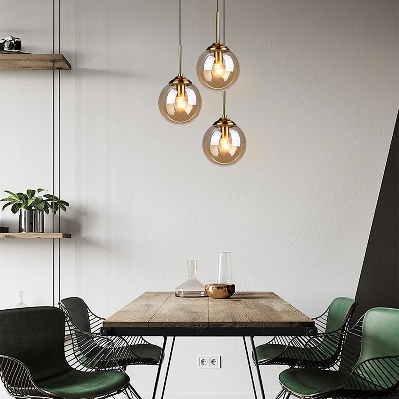 Modern luxury glass LED pendant light hanging above a dining table in a contemporary home.