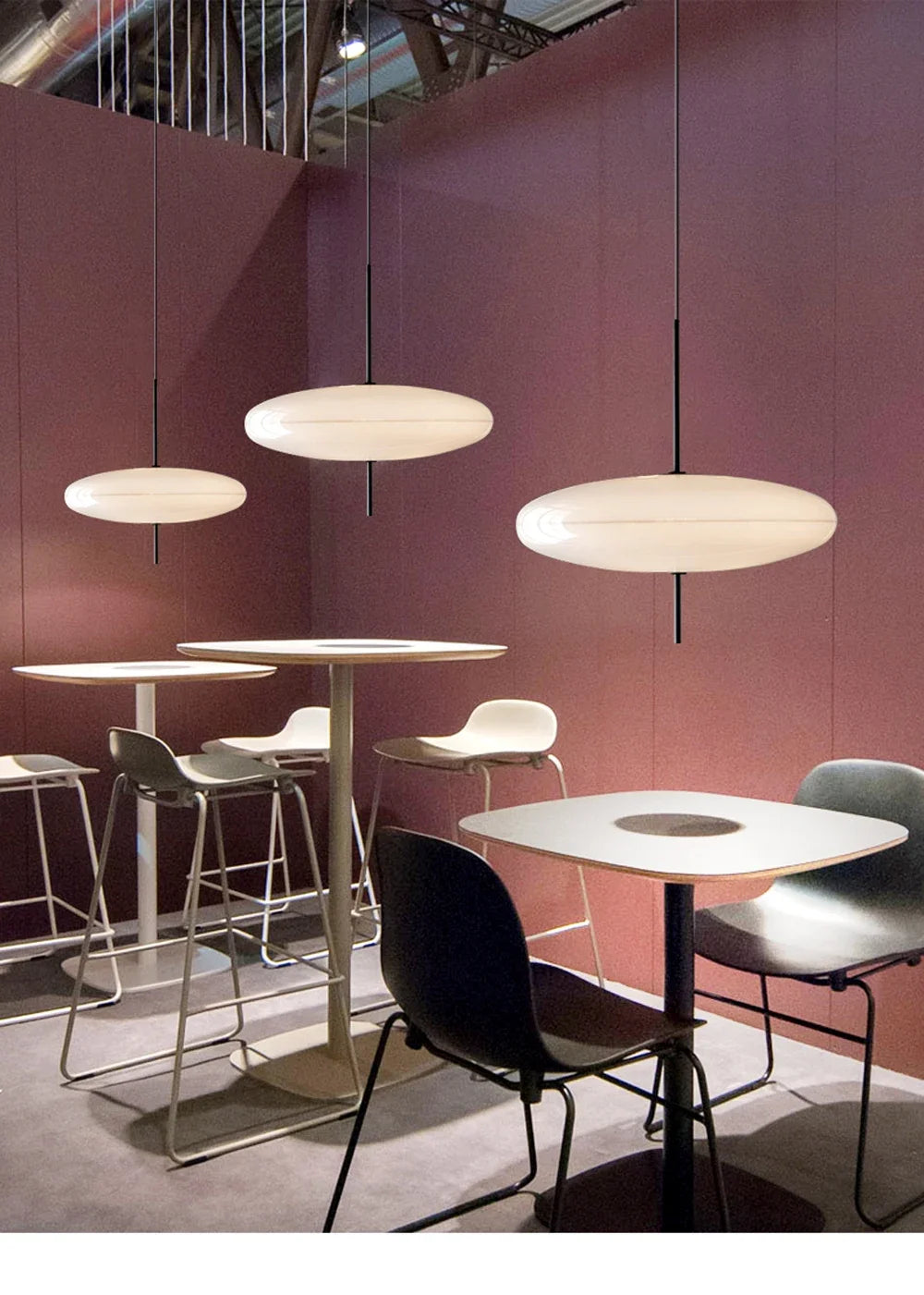 Nordic flying saucer LED pendant light hanging in a modern living room with minimalist décor.