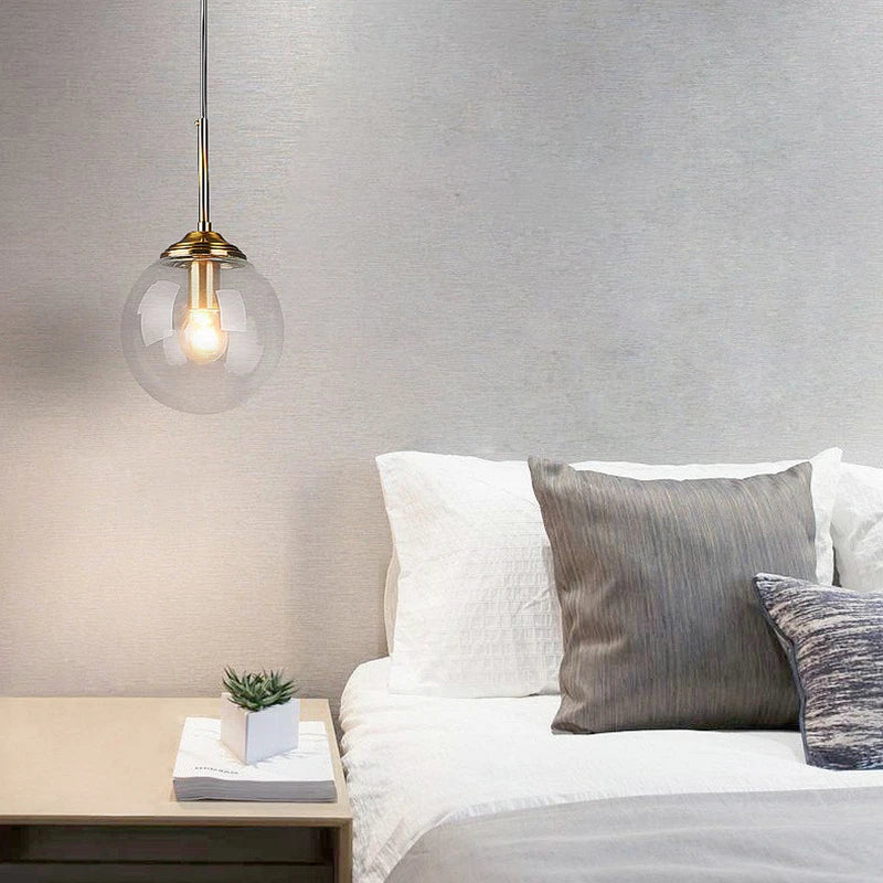 Modern luxury glass LED pendant light hanging above a dining table in a contemporary home.