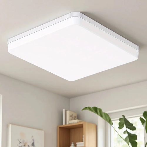 Modern dimmable LED flush mount ceiling light with adjustable white lighting in a contemporary living room.