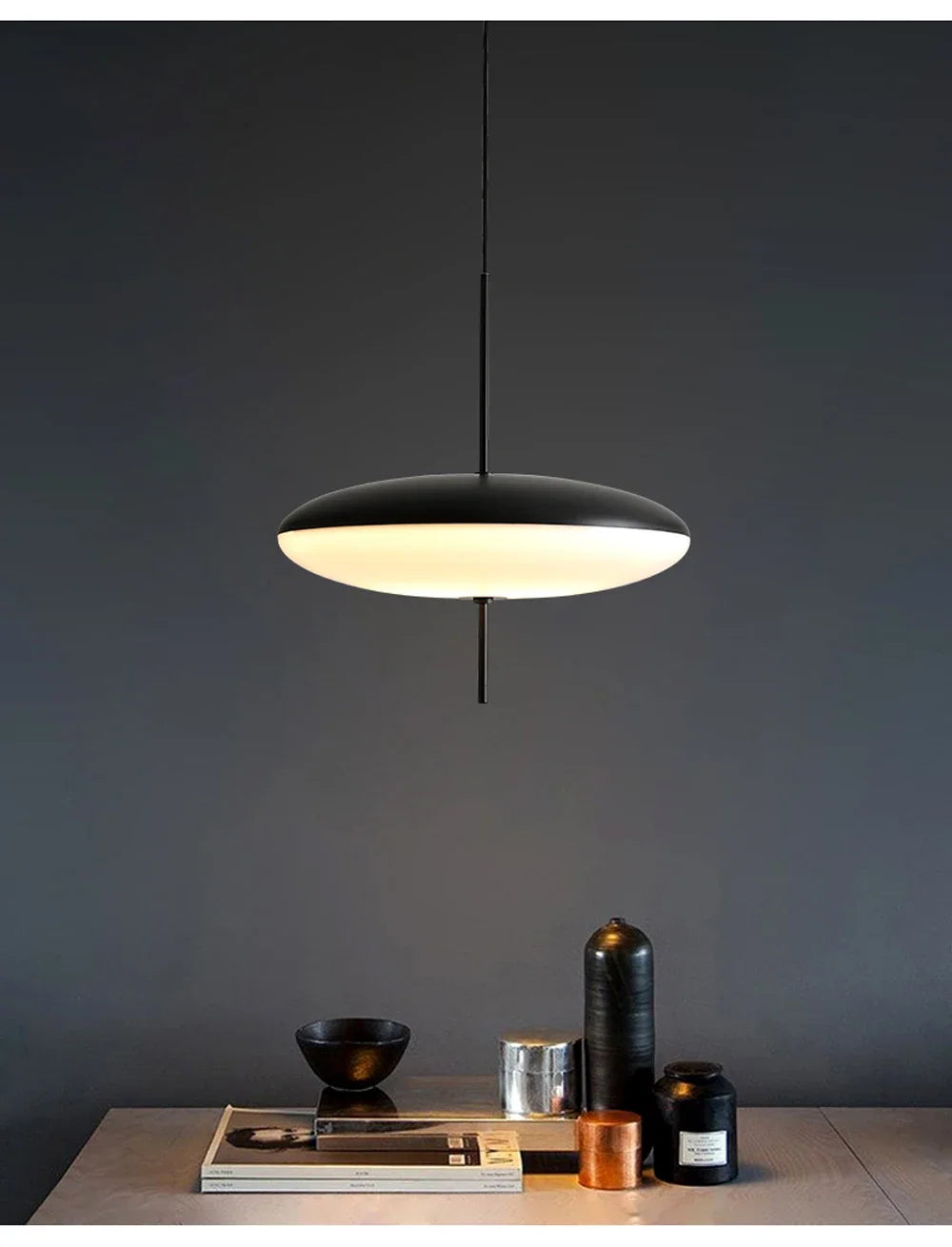 Nordic flying saucer LED pendant light hanging in a modern living room with minimalist décor.