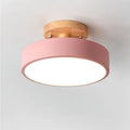 Nordic wood round LED ceiling light installed in a modern hallway with Scandinavian-inspired interior décor.