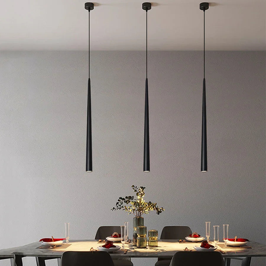 Modern cone LED pendant light hanging above a kitchen island in a contemporary home.