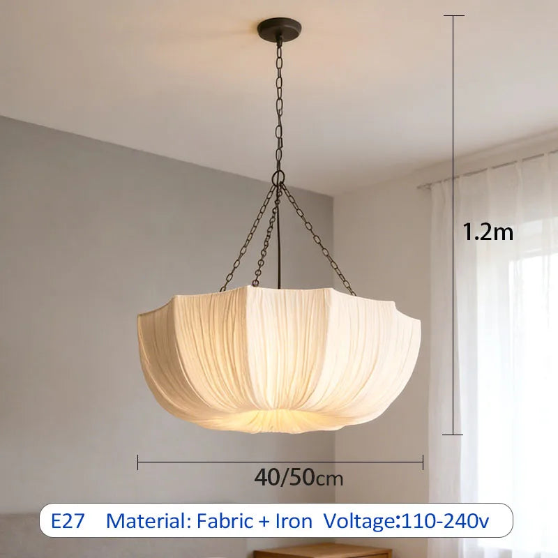 Japanese fabric pendant light with iron chain hanging above a modern dining table in a Japandi-style home.