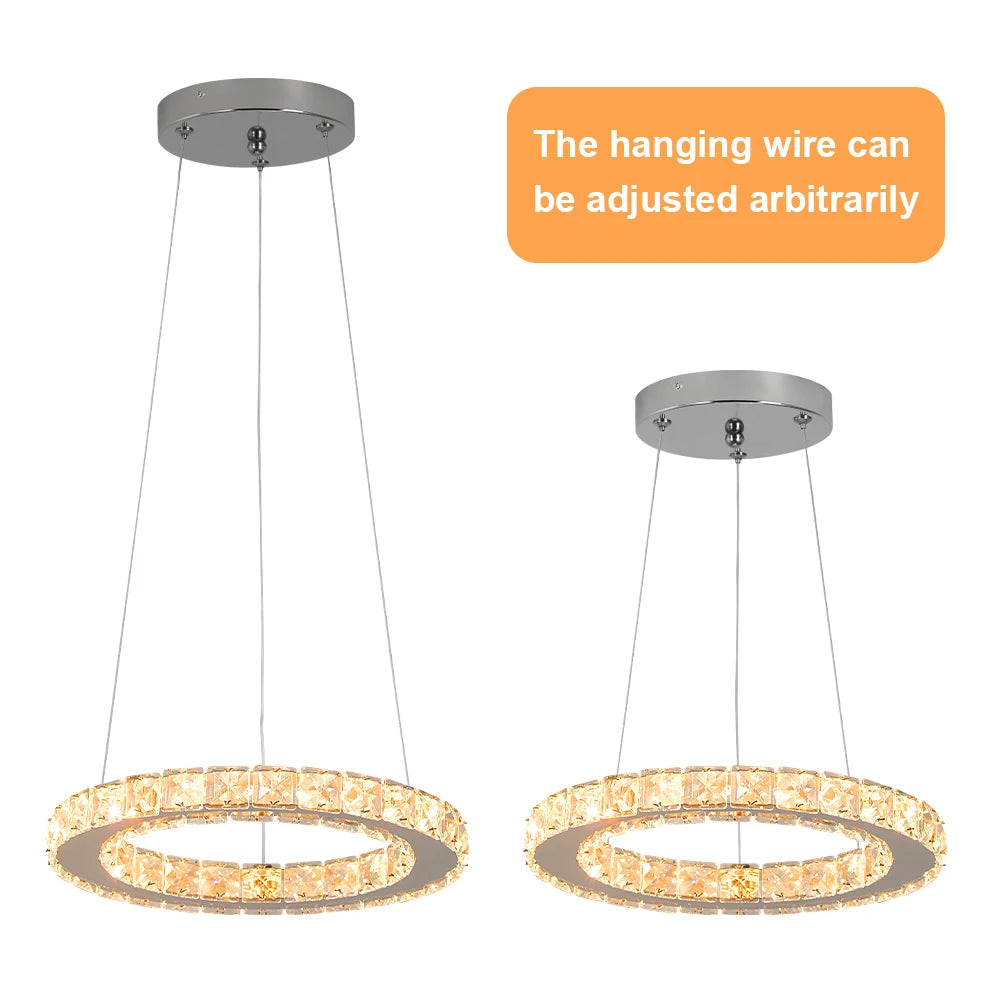 Luxury crystal ring LED chandelier suspended above a modern dining table in an elegant contemporary home.