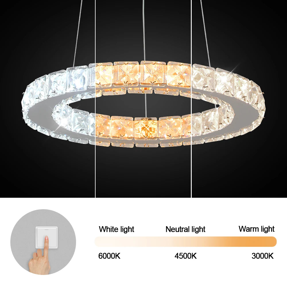 Luxury crystal ring LED chandelier suspended above a modern dining table in an elegant contemporary home.