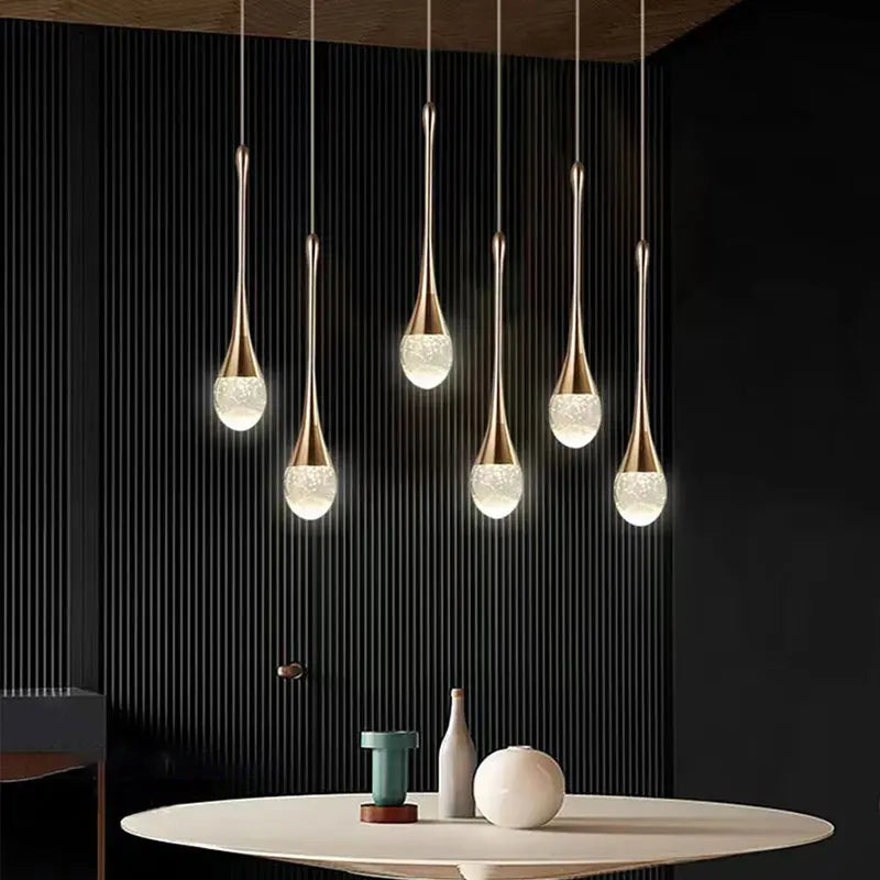 Modern bubble crystal pendant light hanging above a kitchen island in a luxury contemporary home.