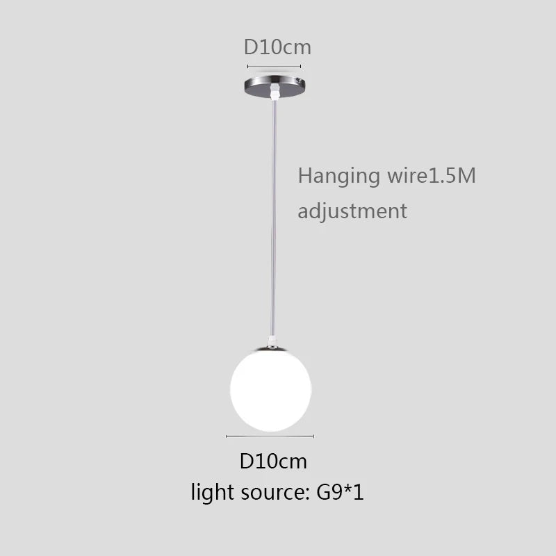 Modern glass globe pendant light with gold finish hanging above a contemporary dining table.