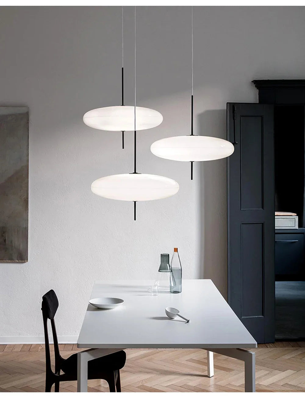 Nordic flying saucer LED pendant light hanging in a modern living room with minimalist décor.