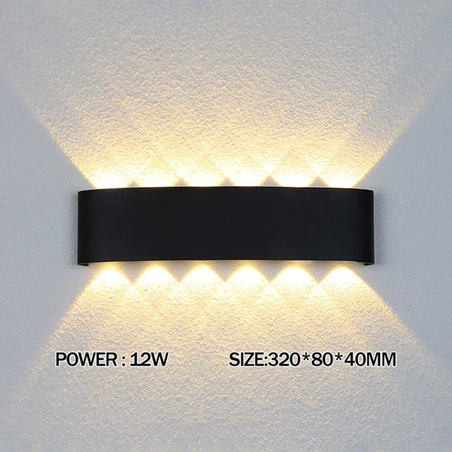 Modern waterproof LED wall light installed on an exterior house wall illuminating a porch and garden.
