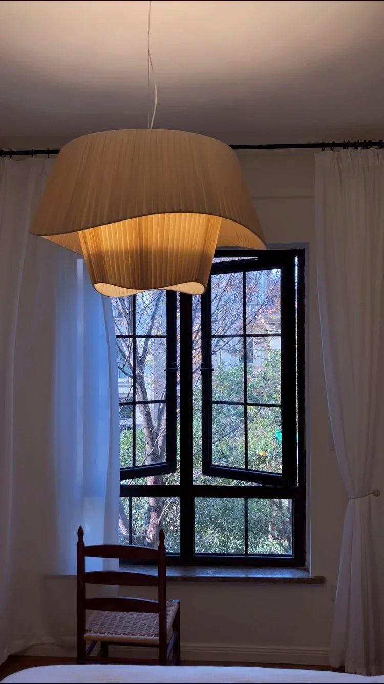 Nordic modern LED pendant light hanging above a dining table in a contemporary living room.