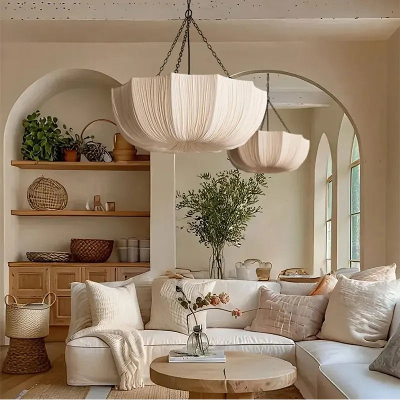 Japanese fabric pendant light with iron chain hanging above a modern dining table in a Japandi-style home.