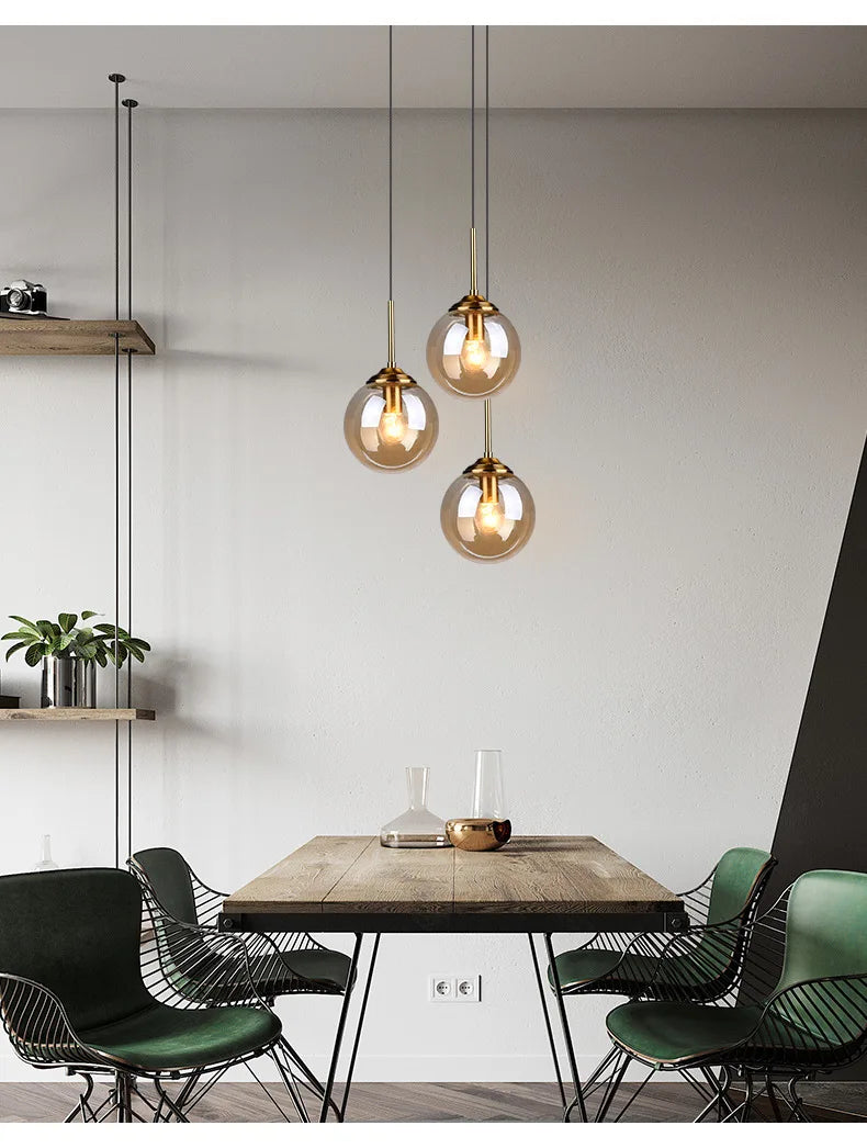 Modern luxury glass LED pendant light hanging above a dining table in a contemporary home.