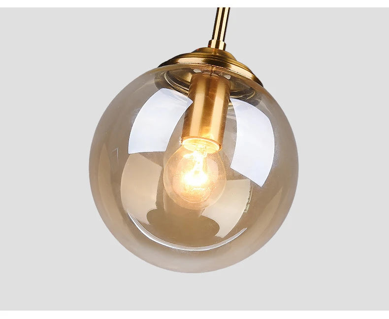 Luxury Nordic glass LED pendant light hanging above a modern dining table in a contemporary home.