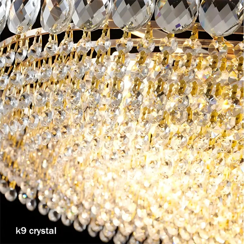 Luxury gold crystal LED chandelier hanging in an elegant modern living room with premium interior décor.