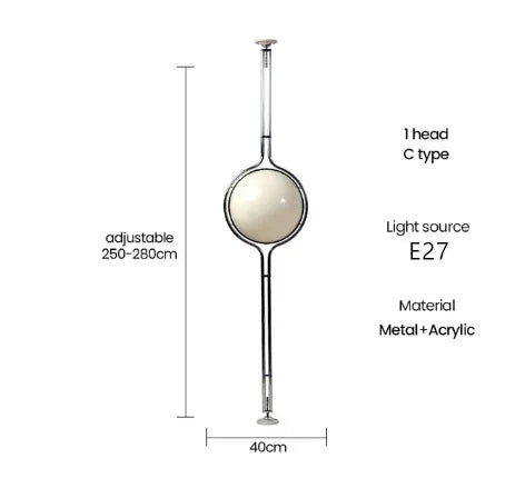 Luxury chrome globe floor lamp with a white acrylic globe beside a modern sofa in a contemporary living room.