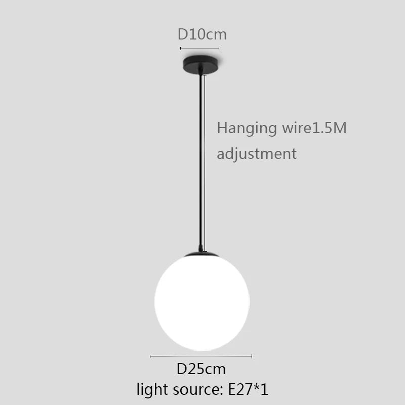 Modern glass globe pendant light with gold finish hanging above a contemporary dining table.