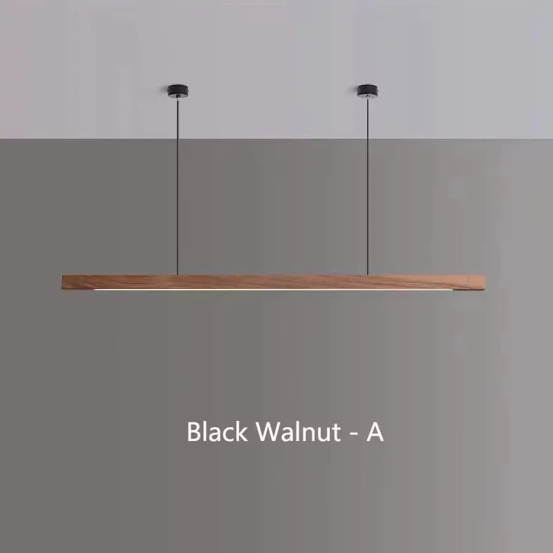 Modern walnut wood LED pendant light suspended above a kitchen island in a contemporary Scandinavian-style home.