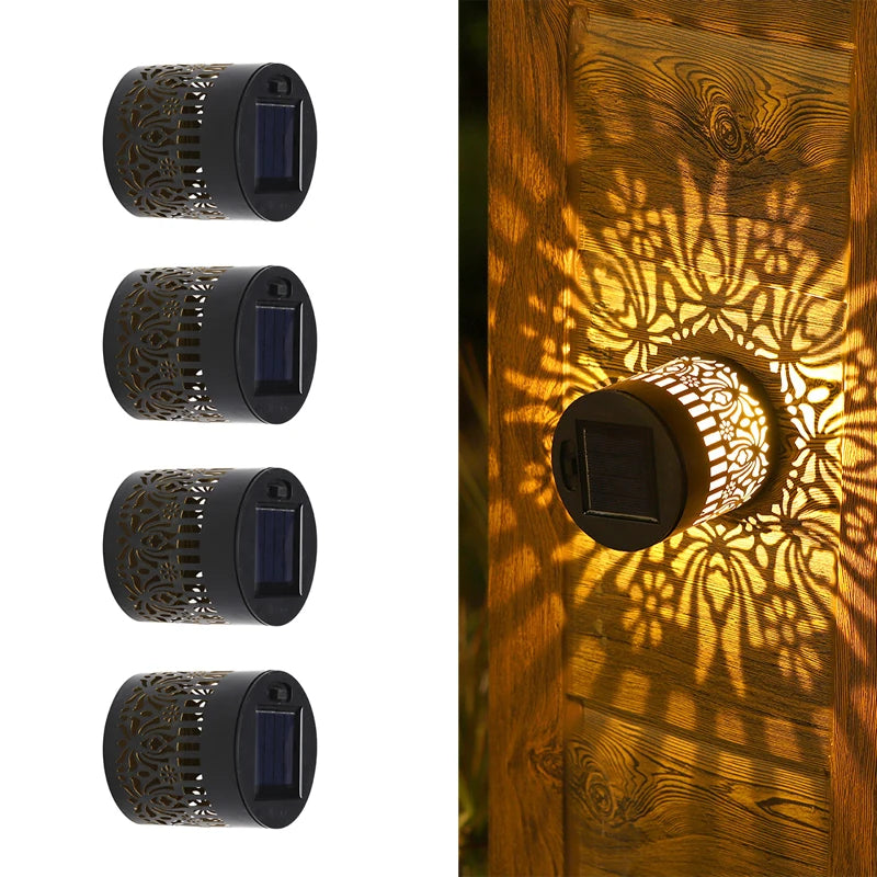 Modern waterproof solar projection LED wall light casting a decorative light pattern on an outdoor garden wall.