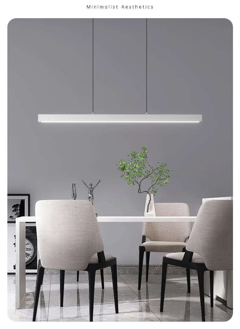 Modern linear LED pendant light suspended above a dining table in a contemporary dining room.