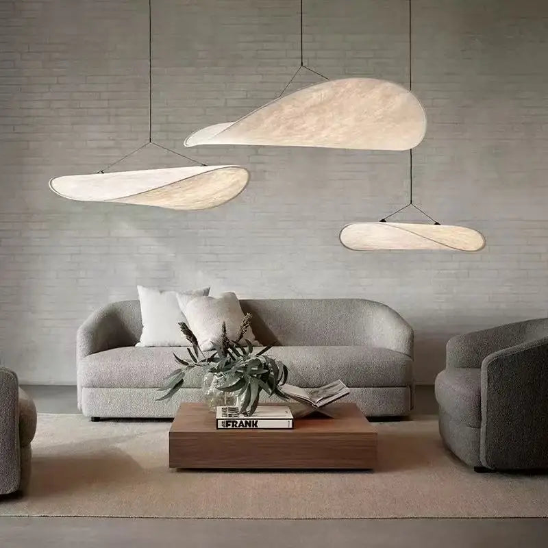 Nordic modern LED pendant light hanging above a dining table in a contemporary living room.