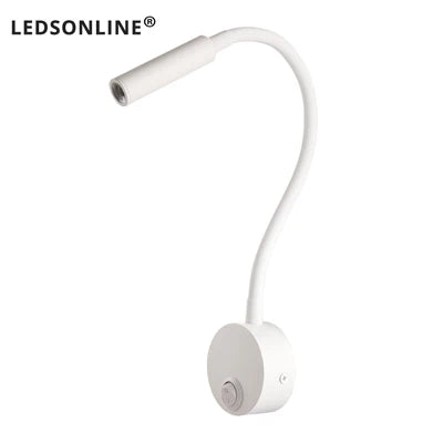 Modern LED wall reading light mounted beside a bed, providing focused lighting for reading.