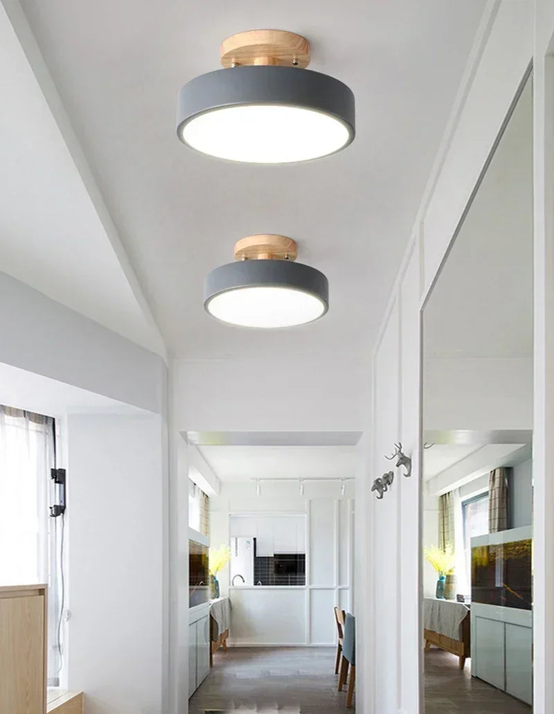Nordic wood round LED ceiling light installed in a modern hallway with Scandinavian-inspired interior décor.