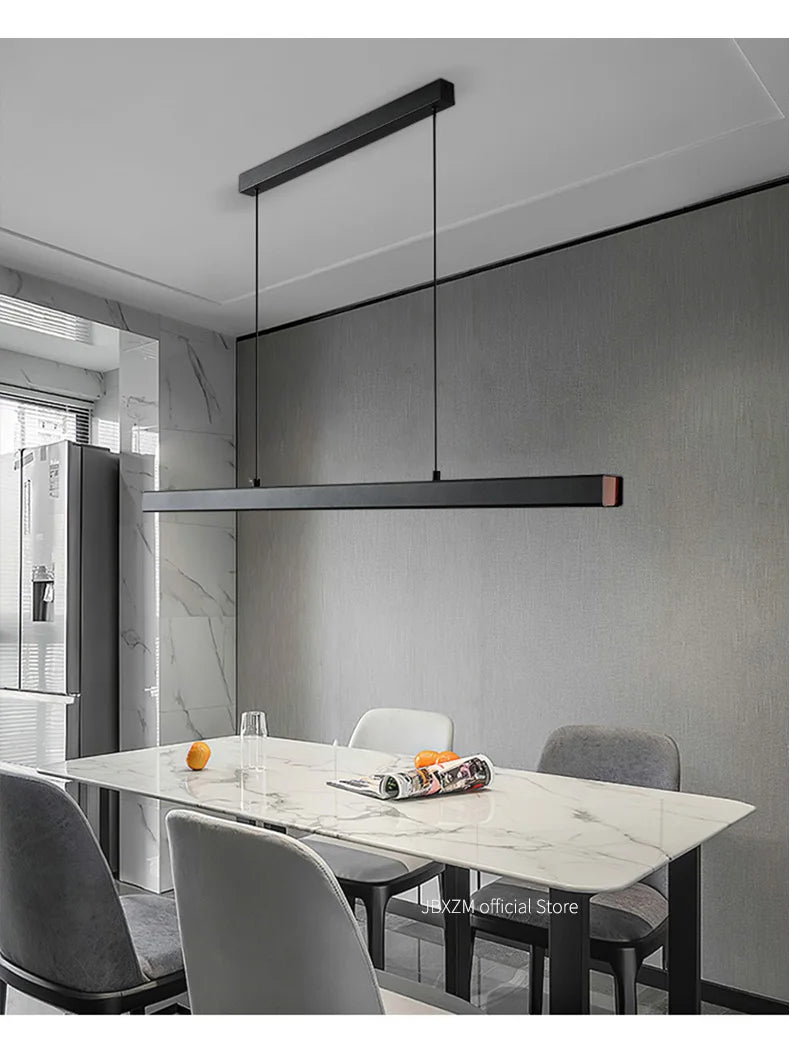 Modern linear LED pendant light suspended above a dining table in a contemporary dining room.