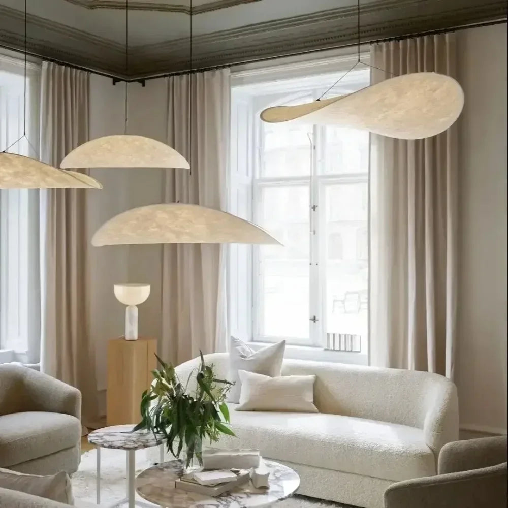 Nordic modern LED pendant light hanging above a dining table in a contemporary living room.