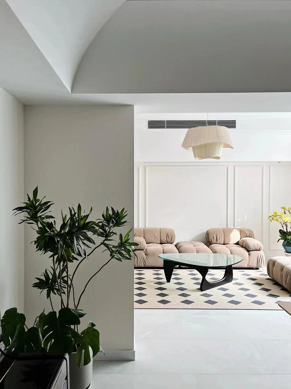 Nordic modern LED pendant light hanging above a dining table in a contemporary living room.