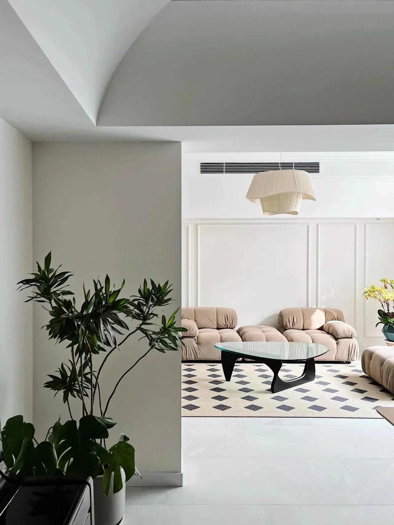 Nordic modern LED pendant light hanging above a dining table in a contemporary living room.