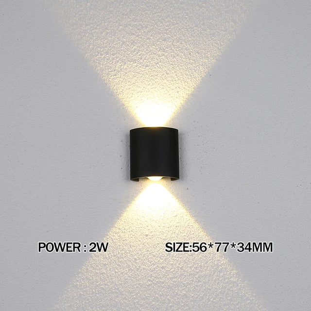 Modern waterproof LED wall light installed on an exterior house wall illuminating a porch and garden.